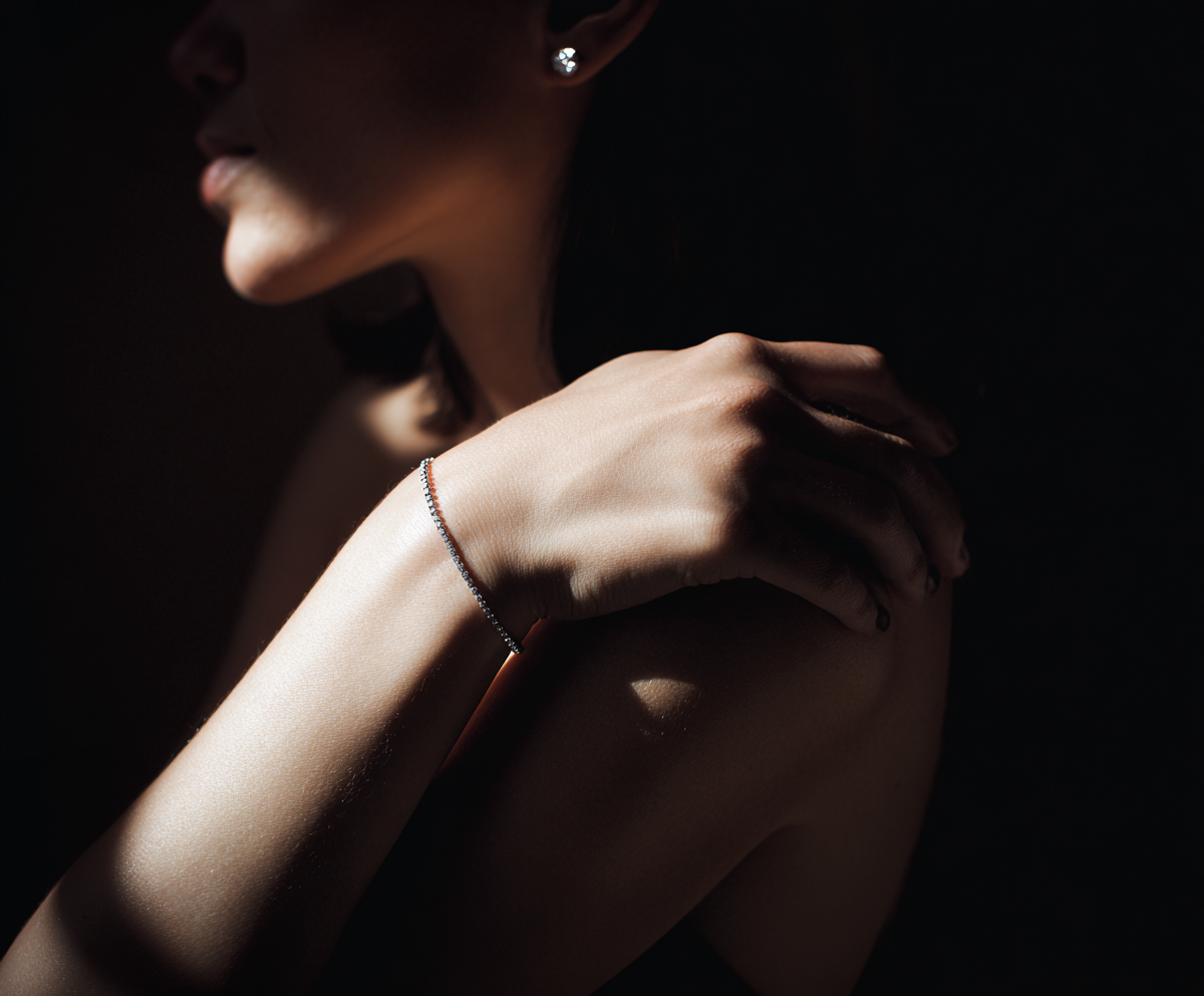 Person wearing a bracelet with a dark background